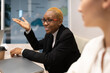 © Cavan Images - Black businesswoman speaking with colleagues during meeting