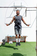 © Cavan Images - Muscular man skipping exercise with jumping rope in gym
