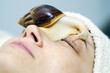 © Cavan Images - A 40-year-old woman rejuvenates her face with a snail