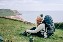 Woman Hiking The Jurassic Coast In England Having A Cup Of Tea Camping