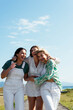 © Cavan Images - Three beautiful girls walking and looking happy