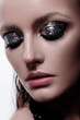 © Cavan Images - Fashion style girl portrait. Beautiful fashion woman with professional styling, hairdress and makeup; dark glitter eyeshadows, rock style beauty portrait