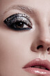 © Cavan Images - Fashion style girl portrait. Beautiful fashion woman with professional styling, hairdress and makeup; dark glitter eyeshadows, rock style beauty portrait