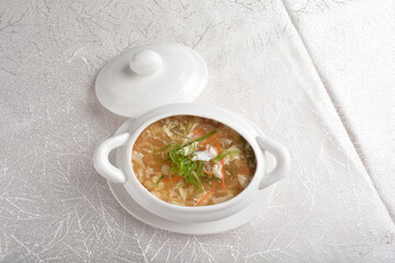 double boiled fish maw shark's fin thick hot soup in white bowl in white background asian halal seafood menu