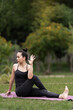 © EduLife Photos - A confident middle-aged Asian woman in sports outfit doing yoga exercise on the yoga mat outdoor in the backyard in the morning. Young woman doing yoga exercise outdoor in nature public park