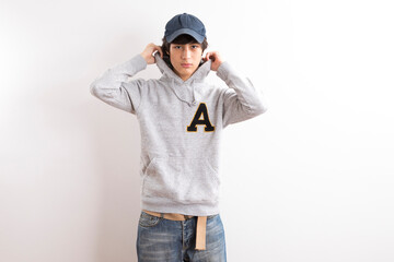 Handsome boy in a white hoodie on white background.