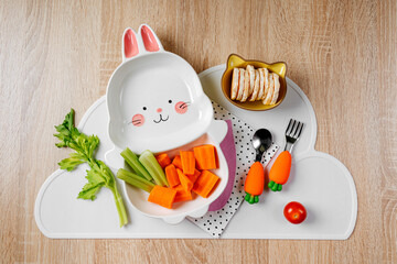 Cute plate in the shape of a bunny with  fresh vegetables. Food idea for kids. Children's healthy food with carrot