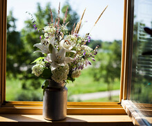 Bouquet Of Lilies Hydrangea And Wild Flowers On A Windowsill On A Bright Summer Day