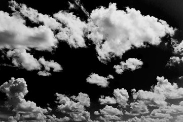 Wall Mural - cloudscape isolated on black sky, black and white cloudscape image