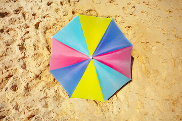 Wall Mural - Colorful sun umbrella on the sand from top above