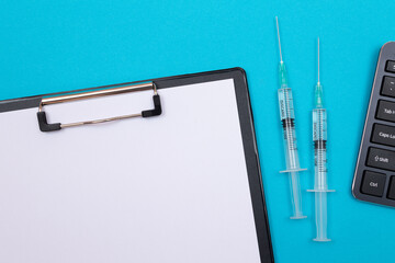 vaccination, immunology or revaccination concept - two medical syringe lying on blue table in doctor