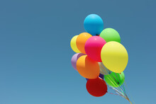 Bunch Of Colorful Balloons Against Blue Sky. Space For Text