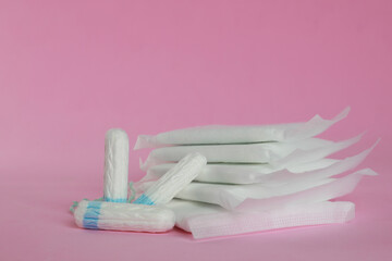 Wall Mural - Menstrual pads and tampons on pink background