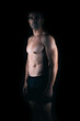 © Samuel Perales - Strong man facing the camera while the light lighting his torso