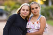 © Austockphoto - two young aboriginal girls outside with heads together