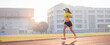 © EduLife Photos - A young Asian woman athlete runner jogging on running track in city stadium in the sunny morning to keep fitness and healthy lifestyle. Young fitness woman runs on stadium track. Sport and recreation