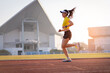 © EduLife Photos - A young Asian woman athlete runner jogging on running track in city stadium in the sunny morning to keep fitness and healthy lifestyle. Young fitness woman runs on stadium track. Sport and recreation
