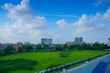 Kolkata cityscape , old and modern architecture of buildings, blue sky and white clouds in background with green field foreground.