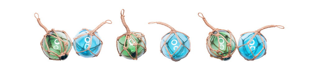 Glass fishing round buoys. Many of glass spheres with ropes isolated on white background.
