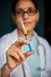 © Bhawna - Close-up female doctor holding injection in hand.