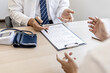 © kamiphotos - Doctors and patients are talking in the examination room of a private hospital, they are discussing symptoms and treatment of detected diseases. Concept of examination and treatment of disease.