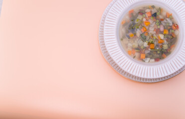 Sticker - Top view of vegetable soup on a bowl isolated on light orange background