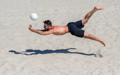 Professional beach volleyball player in action, receiving the ball. Horizontal sport poster, greeting cards, headers, website