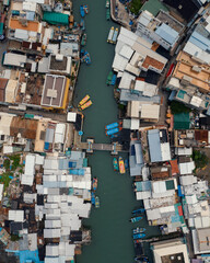 drone shot of large river dividing the town in two sections and bridge