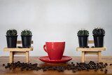 Fototapeta Kuchnia - Making hot coffee on wooden table. Espresso coffee and coffee beans with cactus background show on table relaxing concept of the day.