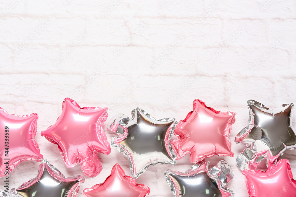 Festive air balloons on light brick background