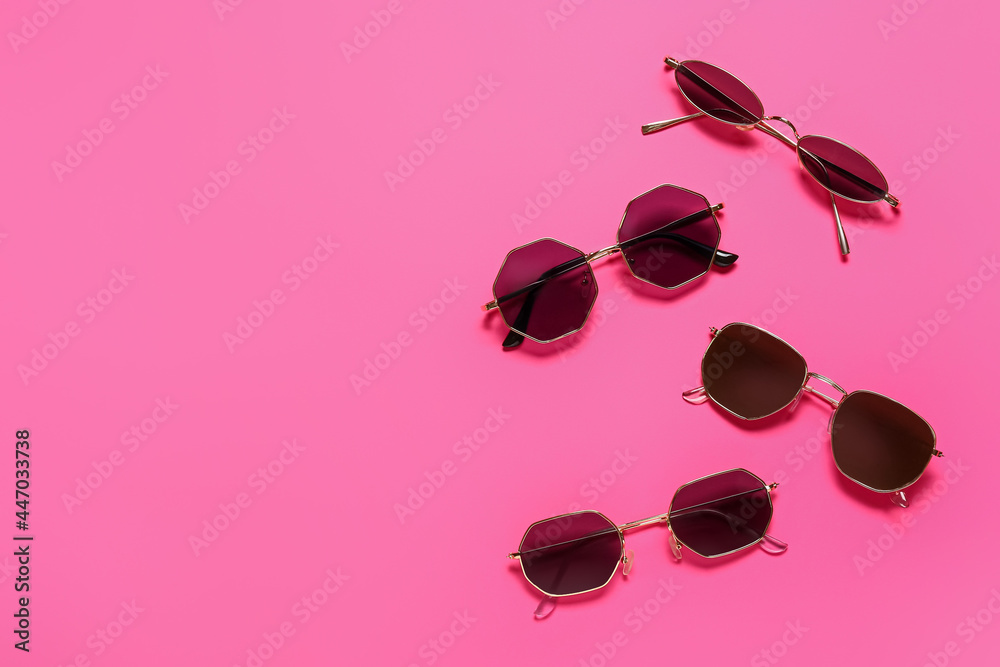 Stylish sunglasses on color background
