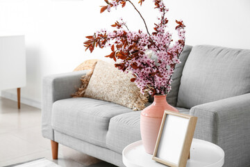 Wall Mural - Vase with blossoming branches on table in living room