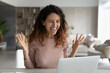 Overjoyed millennial Latino woman look at laptop screen feel euphoric read good news online. Smiling excited young Hispanic female triumph with promotion offer or discount sale deal on computer.