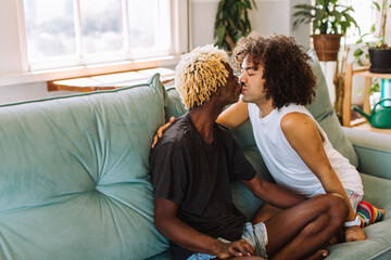 Wall Mural - Passionate gay couple sharing a kiss at home