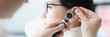 © H_Ko - Otorhinolaryngologist examines patient ear with an otoscope
