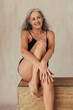 © Jacob Lund - Cheerful mature woman posing in her natural body