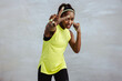 © Jacob Lund - African sportswoman exercising with peace handsign