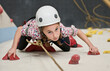 © Cavan Images - girl climbing at indoor climbing wall in London