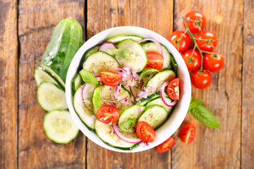 Wall Mural - cucumber salad with cherry tomato and basil