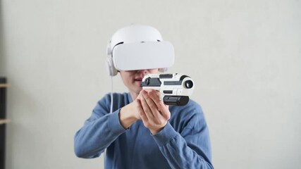 Wall Mural - man is playing game with virtual reality headset and blaster.