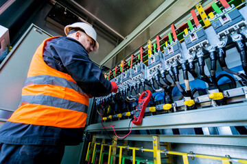 Wall Mural - checking the operating voltage levels of the solar panel switchgear compartment