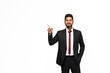 Young, stylish indian manager in a classic suit pointing his finger on a white isolated background