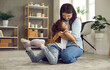 © Studio Romantic - Candid shot of happy mother and child playing at home. Cheerful young mom and cute little daughter hugging sitting on warm rug in the living room. Concept of love between parents and kids