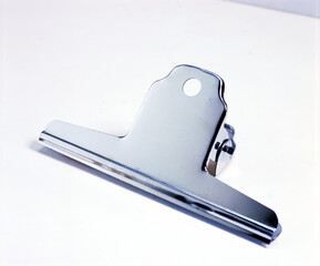 Poster - Closeup of a big silver metal clip isolated on a white background