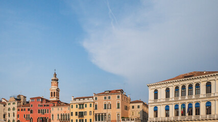 Canvas Print - Tower over colorful Venetian houses under blue sky, Venice, Italy