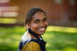 © Austockphoto - head and shoulders of smiling teenage girl looking over shoulder at camera