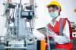 © tonefotografia - Quality control (QC) engineer monitoring and checking machine system in manufacturing factory