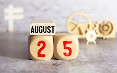 August 25 - from wooden blocks with letters, important date concept, white background random letters around.