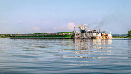 Wall Mural - River barge and tugboat carrying cargo on the river