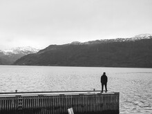 Lofoten, Norway: Man Standing In The Rain On The Pier 